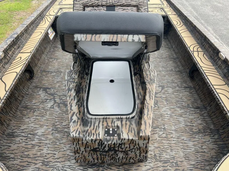 Slide: The Image of 2025 Xpress X23B Lounge boat interior with camo design and storage compartment. - 14