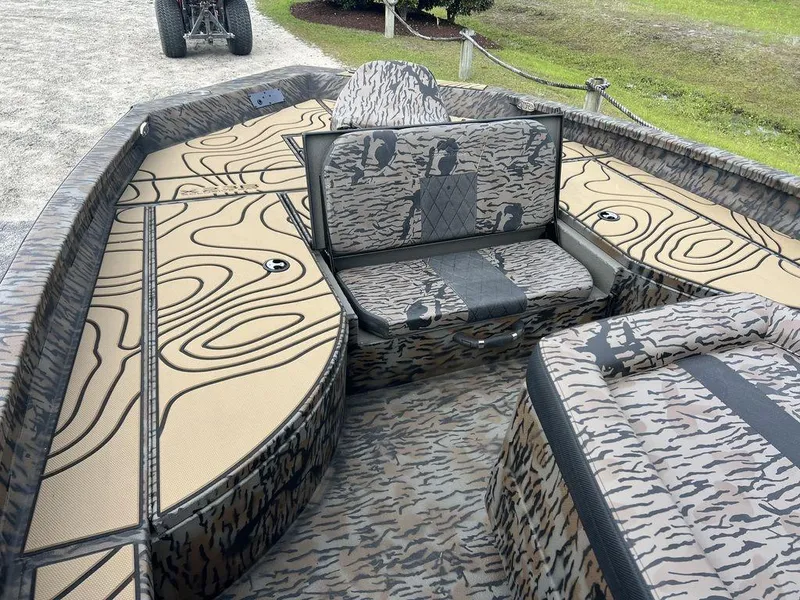 Slide: The Image of 2025 Xpress X23B Lounge boat interior with camouflage design and seating. - 15