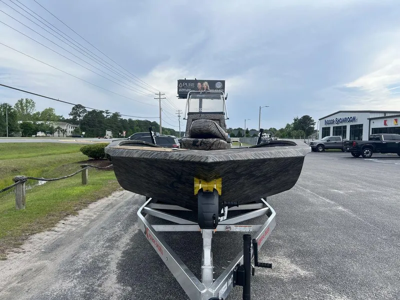 Slide: The Image of 2025 Xpress X23B Lounge boat on trailer in parking lot. - 7