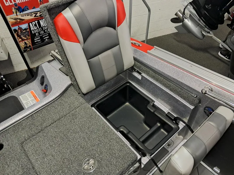 Slide: The Image of 2025 Nitro ZV2O SPT PRO boat interior with storage compartment and cushioned seats. - 11