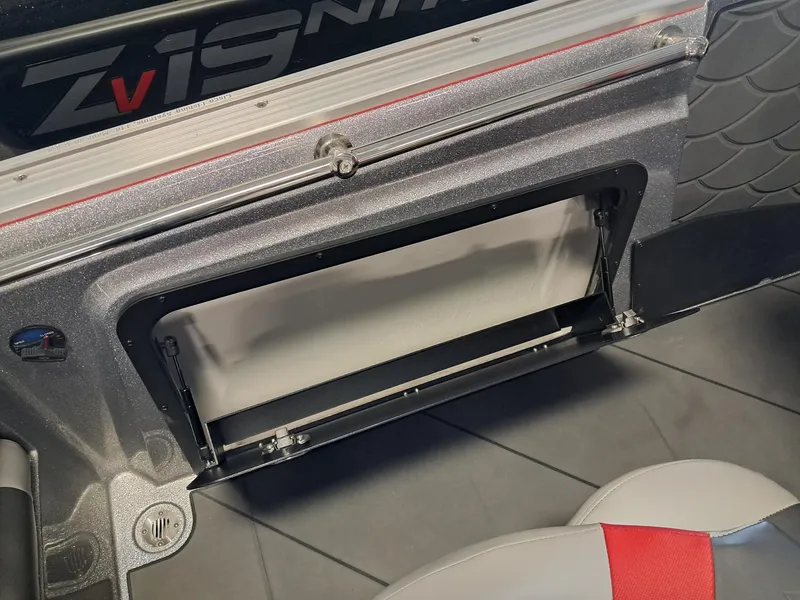 Slide: The Image of 2025 Nitro ZV2O SPT PRO boat storage compartment with open hatch, showcasing interior design. - 13