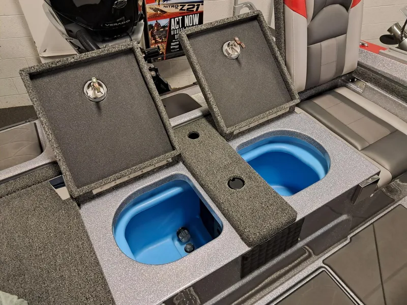 Slide: The Image of 2025 Nitro ZV2O SPT PRO boat with open storage compartments and seating. - 9