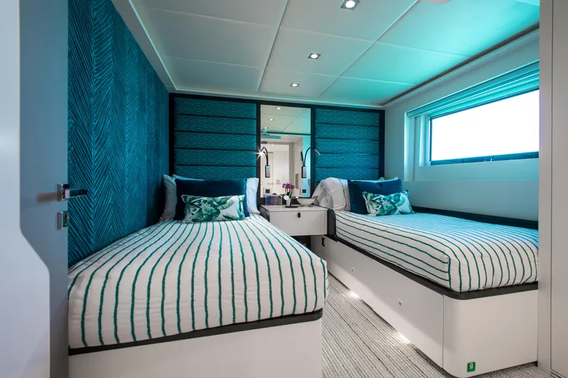 Slide: The Image of Luxurious twin bedroom on 2017 Mengi Yay 105 Custom Explorer yacht, featuring modern decor and ample lighting. - 10