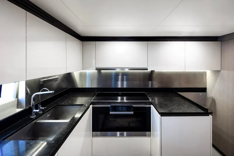 Slide: The Image of Modern kitchen interior on 2017 Azimut Grande 30 Metri yacht, featuring sleek design and stainless steel accents. - 14