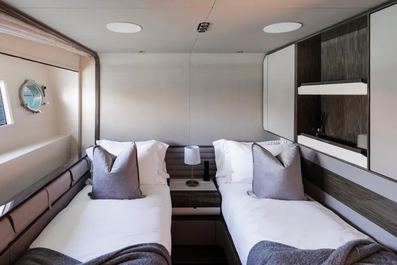Slide: The Image of Luxurious twin cabin in 2017 Azimut Grande 30 Metri yacht, featuring modern decor and cozy bedding. - 20