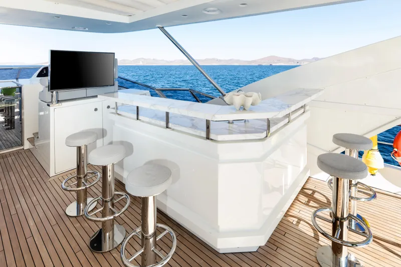 Slide: The Image of Luxurious Azimut Grande 30 Metri yacht deck with bar, stools, and ocean view, 2017 model. - 26