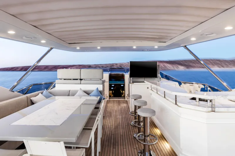 Slide: The Image of Luxurious Azimut Grande 30 Metri yacht interior, featuring elegant seating and a modern bar area. - 28