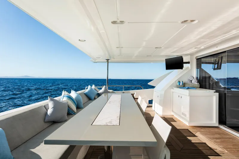 Slide: The Image of Luxurious Azimut Grande 30 Metri yacht deck with seating, table, and ocean view. - 9