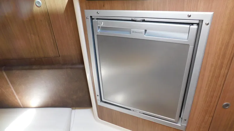 Slide: The Image of 2017 Boston Whaler 315 Conquest interior with built-in stainless steel refrigerator. - 10