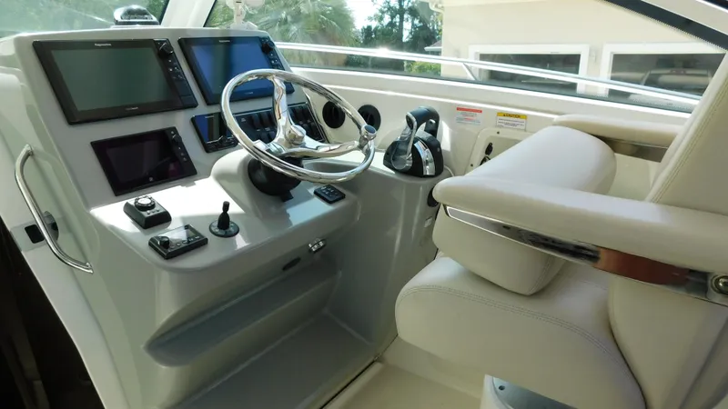 Slide: The Image of 2017 Boston Whaler 315 Conquest helm with modern controls and navigation screens. - 20