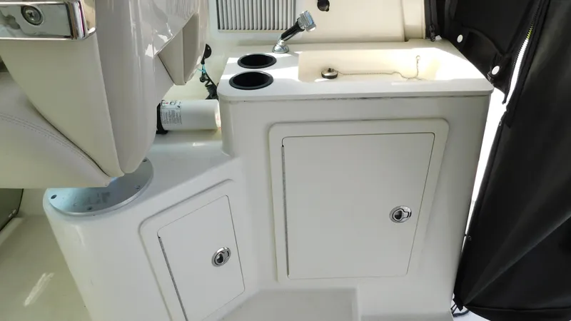 Slide: The Image of 2017 Boston Whaler 315 Conquest boat interior with sink and storage compartments. - 21