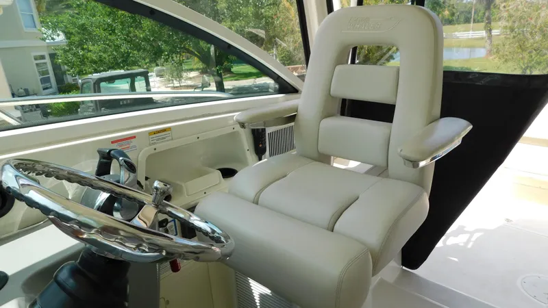 Slide: The Image of Captain's chair and steering wheel on 2017 Boston Whaler 315 Conquest boat. - 23