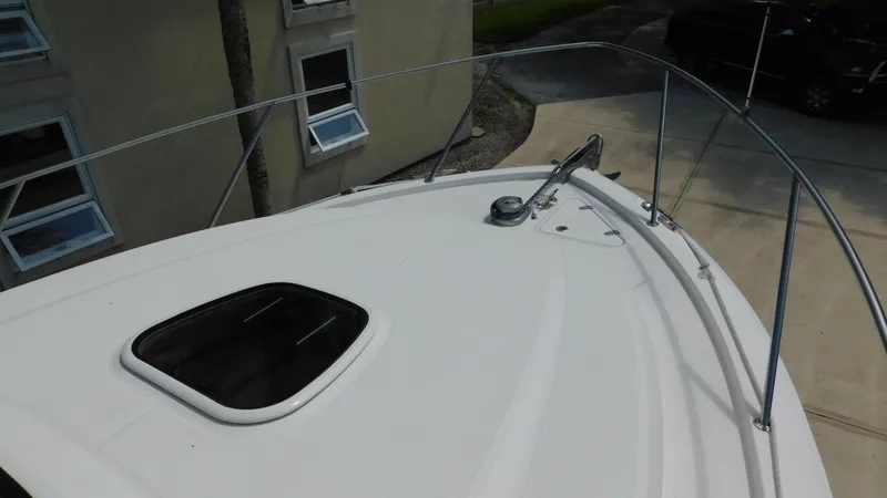 Slide: The Image of 2017 Boston Whaler 315 Conquest boat deck with railing and hatch. - 27