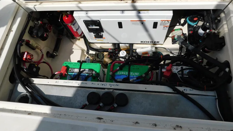 Slide: The Image of Engine compartment of a 2017 Boston Whaler 315 Conquest with Kohler generator and batteries. - 39