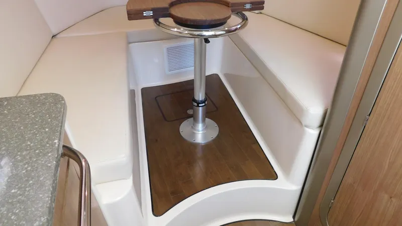 Slide: The Image of 2017 Boston Whaler 315 Conquest cabin interior with seating and table. - 4