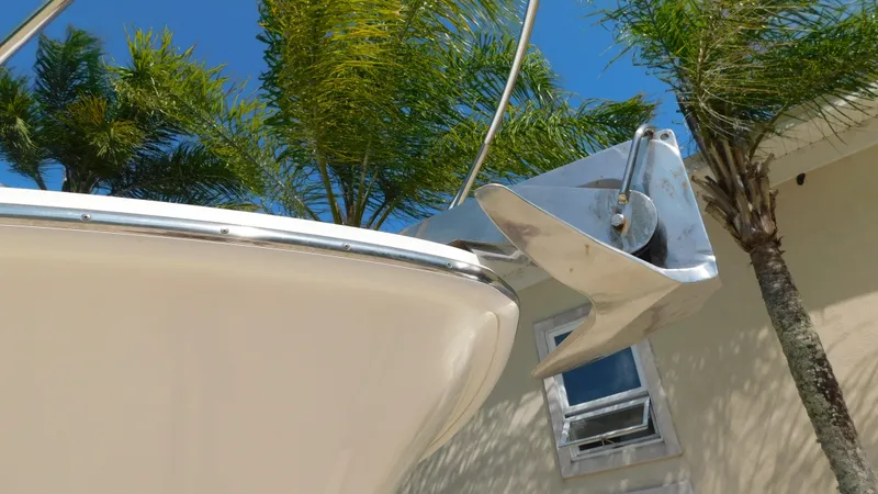 Slide: The Image of 2017 Boston Whaler 315 Conquest bow with anchor, palm trees, and blue sky background. - 45