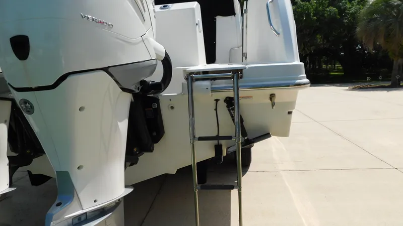 Slide: The Image of 2017 Boston Whaler 315 Conquest boat with ladder and outboard motor. - 46
