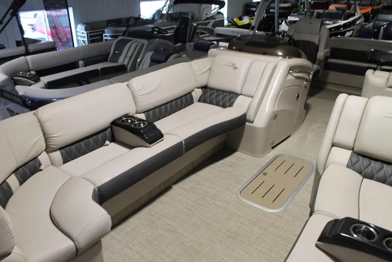 Slide: The Image of 2018 Bennington 25RSB pontoon boat interior with beige seating and cup holders. - 1