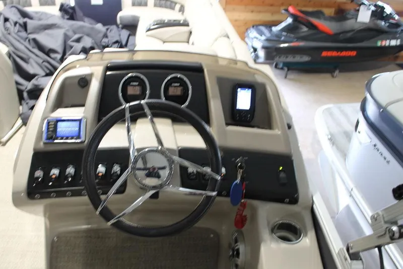 Slide: The Image of 2018 Bennington 25RSB boat dashboard with steering wheel and control panel. - 10