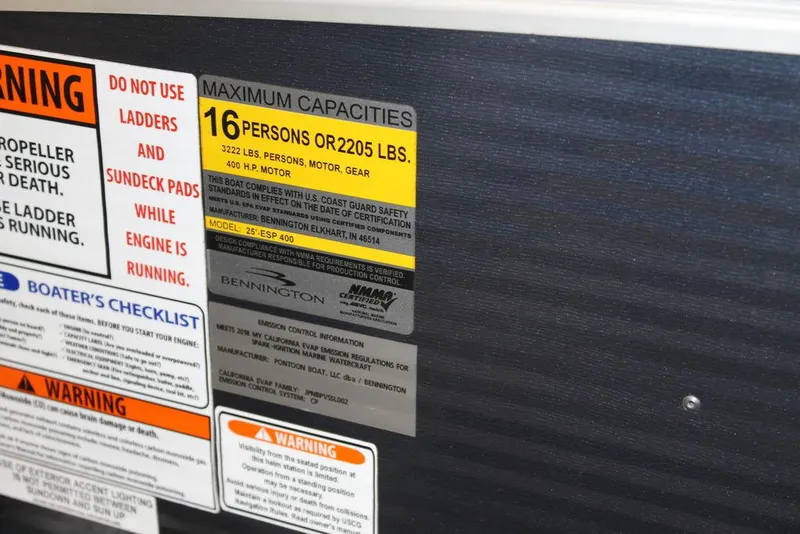 Slide: The Image of 2018 Bennington 25RSB capacity and safety warning labels, maximum 16 persons or 2205 lbs. - 12