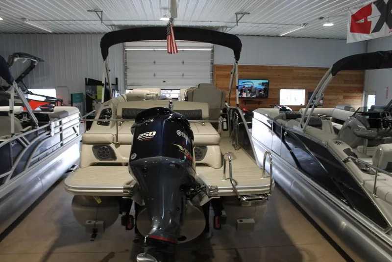 Slide: The Image of 2018 Bennington 25RSB pontoon boat with outboard motor in a showroom. - 16