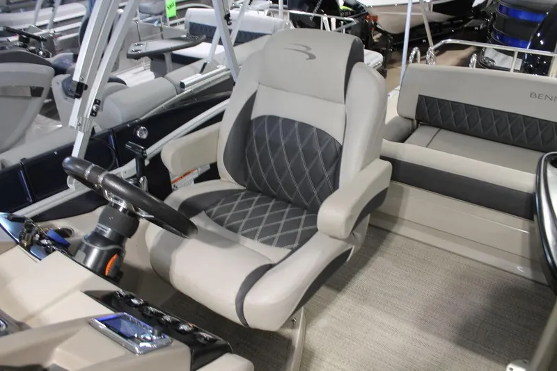 Slide: The Image of 2018 Bennington 25RSB boat interior with plush captain's chair and steering console. - 8