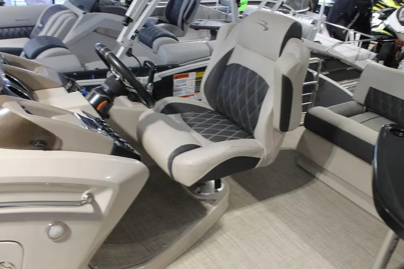 Slide: The Image of 2018 Bennington 25RSB boat interior with luxurious captain's chair and steering console. - 9
