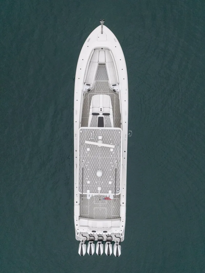 Slide: The Image of Aerial view of 2021 HCB Suenos boat on water, showcasing sleek design and powerful engines. - 12