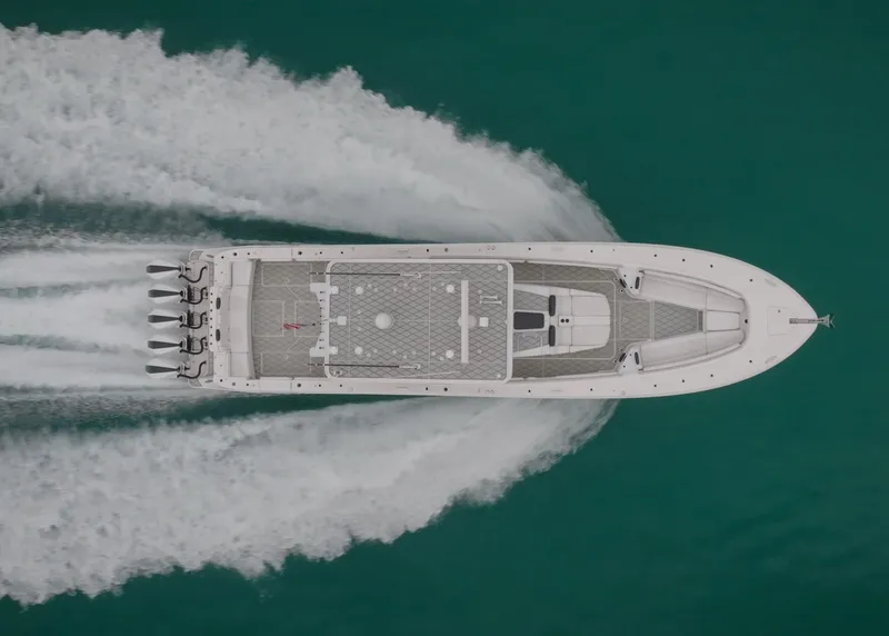 Slide: The Image of Aerial view of 2021 HCB Suenos boat speeding on turquoise water. - 13
