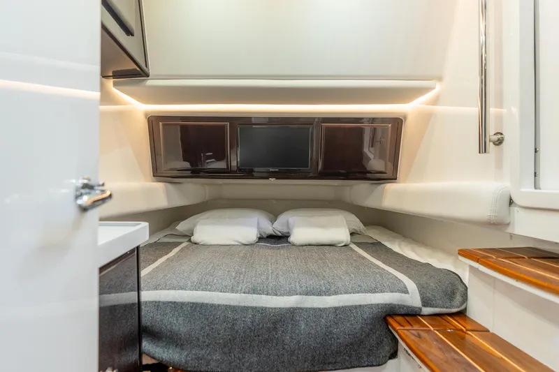 Slide: The Image of 2021 HCB Suenos cabin interior with cozy bed, modern lighting, and wooden accents. - 14