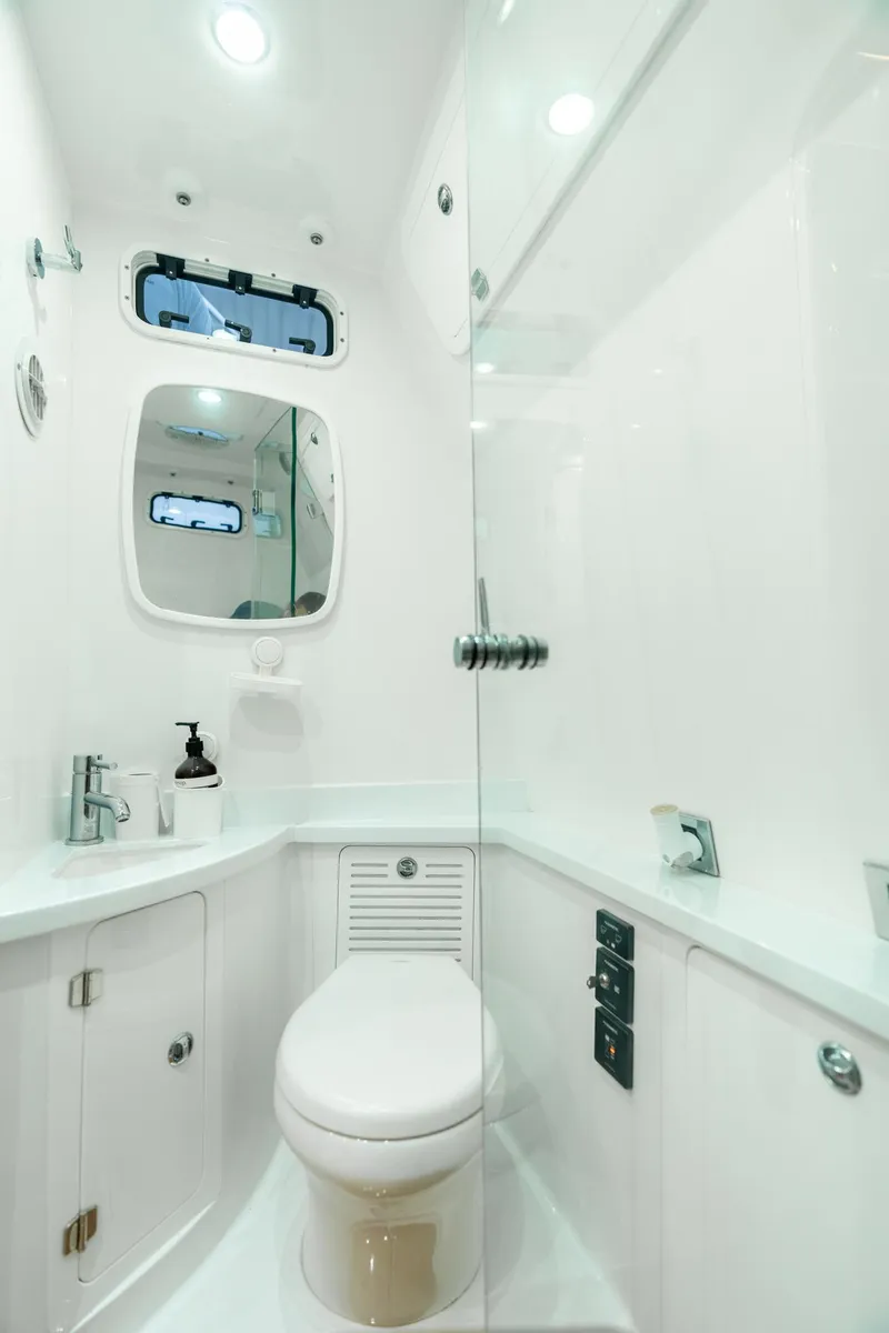 Slide: The Image of 2021 HCB Suenos boat bathroom with modern fixtures and sleek white design. - 18