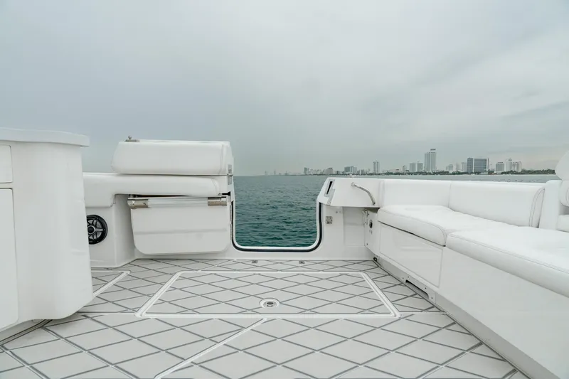 Slide: The Image of Luxurious 2021 HCB Suenos yacht deck with ocean view and city skyline in the background. - 20