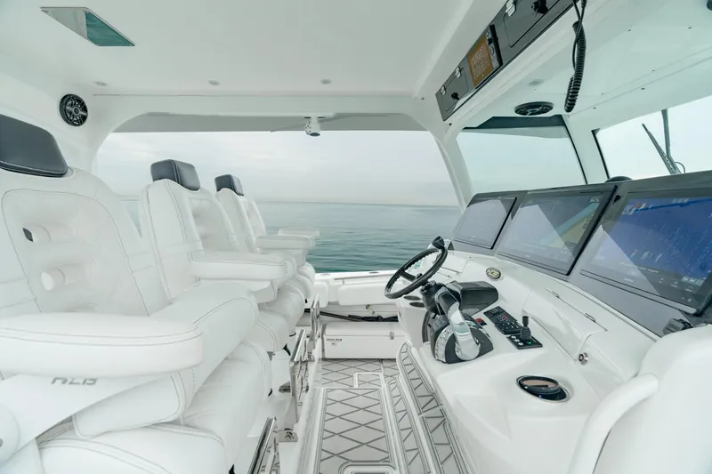 Slide: The Image of 2021 HCB Suenos boat interior with luxurious white seating and advanced navigation system. - 28