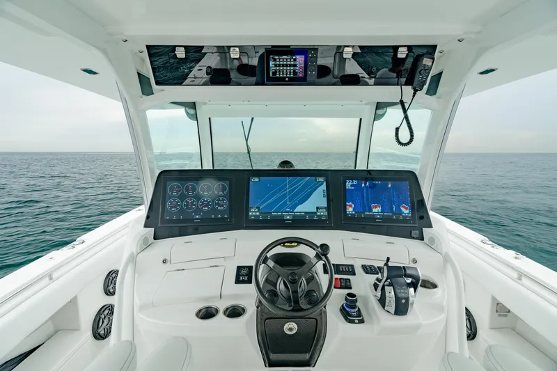Slide: The Image of Helm of 2021 HCB Suenos boat with advanced navigation displays and controls. - 29