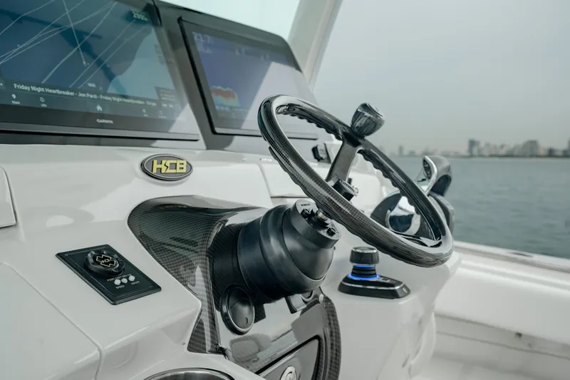 Slide: The Image of 2021 HCB Suenos boat helm with steering wheel and navigation screens. - 31