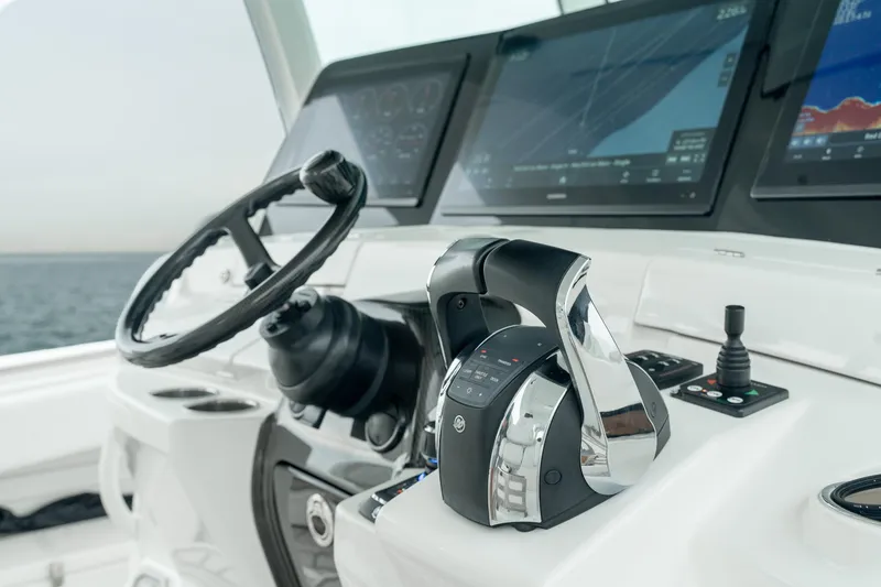 Slide: The Image of 2021 HCB Suenos boat helm with steering wheel and advanced navigation screens. - 32