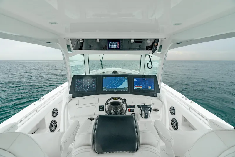 Slide: The Image of 2021 HCB Suenos boat helm with advanced navigation screens and ocean view. - 33
