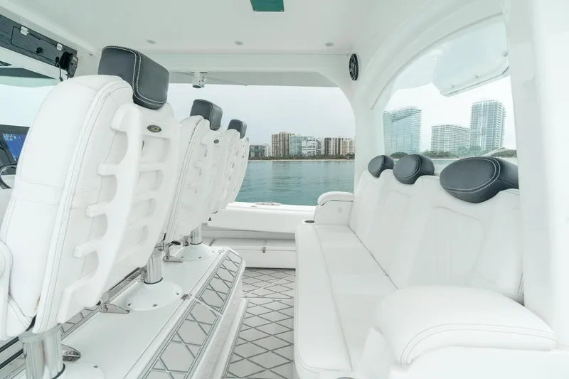 Slide: The Image of Interior of 2021 HCB Suenos boat with luxurious white seating and waterfront view. - 34