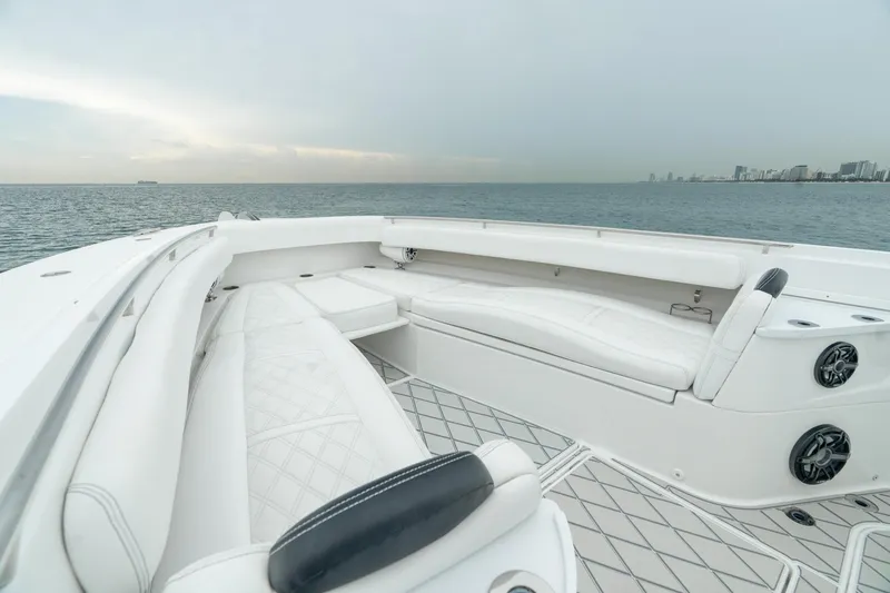 Slide: The Image of Luxurious 2021 HCB Suenos yacht with spacious white seating, cruising on calm waters. - 37