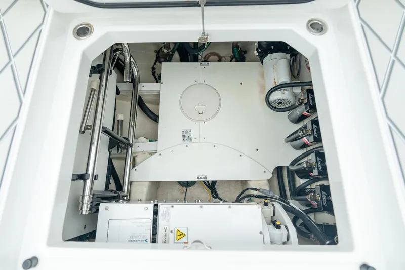 Slide: The Image of Engine compartment of 2021 HCB Suenos boat, showcasing mechanical components and wiring. - 43