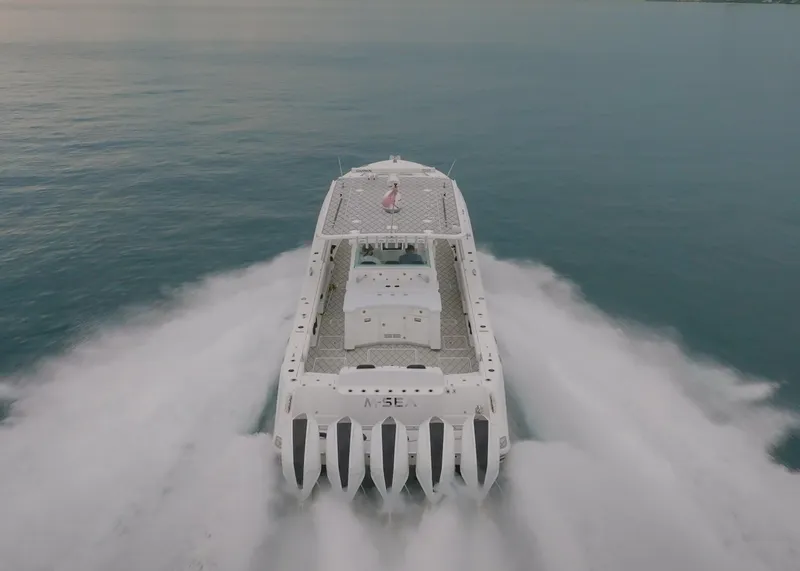 Slide: The Image of HCB Suenos 2021 boat cruising on open water, aerial rear view. - 45