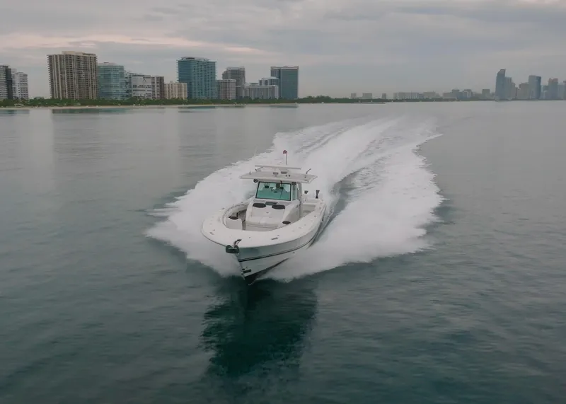Slide: The Image of 2021 HCB Suenos boat cruising on calm water near city skyline. - 5