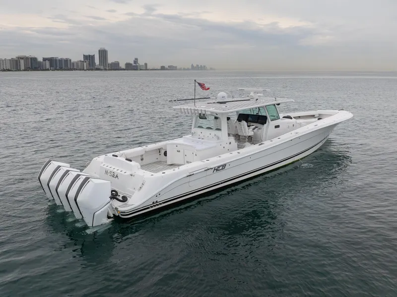 Slide: The Image of 2021 HCB Suenos boat on water with city skyline in background. - 7