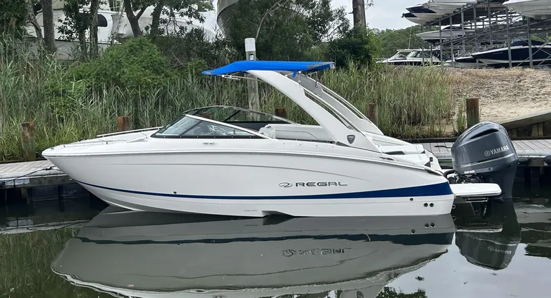 The Image of 2026 Regal LX4 boat docked, featuring sleek design and Yamaha outboard motor. - 1