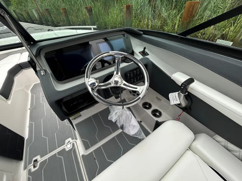 Slide: The Image of 2026 Regal LX4 boat interior with sleek steering wheel and modern dashboard controls. - 11