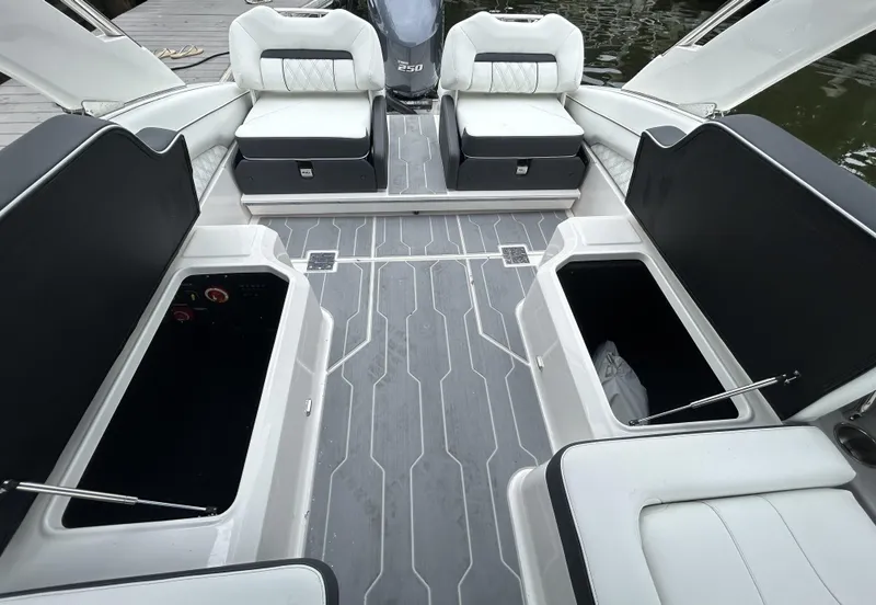 Slide: The Image of 2026 Regal LX4 boat interior with open storage compartments and cushioned seating. - 8