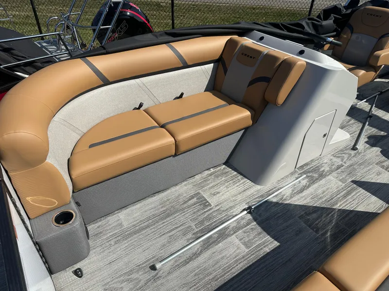Slide: The Image of 2024 Crest Classic LX 220 boat interior with tan seating and modern design. - 4