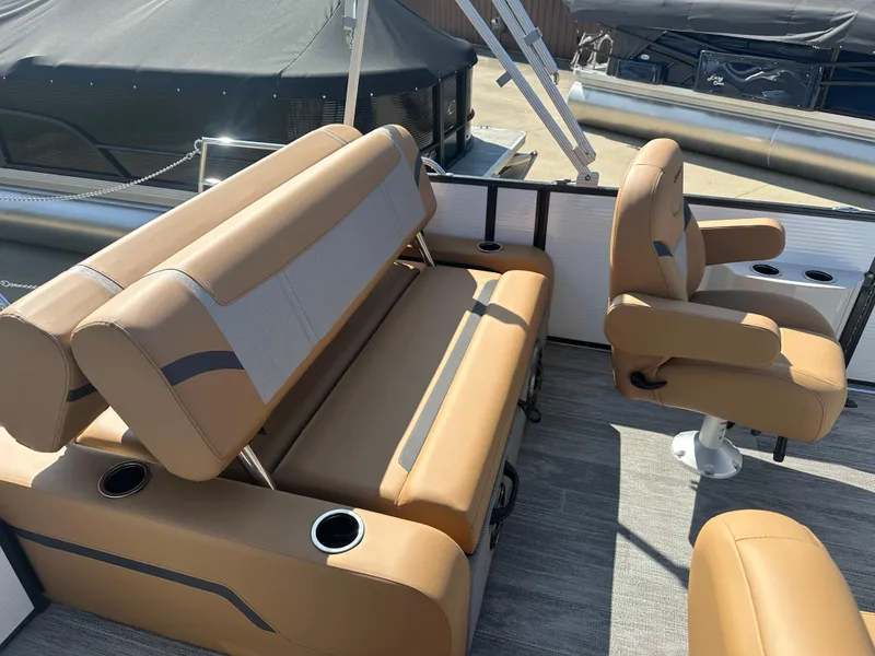 Slide: The Image of 2024 Crest Classic LX 220 boat interior with tan seating and cup holders. - 7