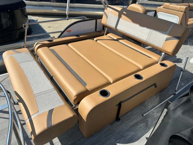 Slide: The Image of 2024 Crest Classic LX 220 boat interior with tan seating and cup holders. - 9