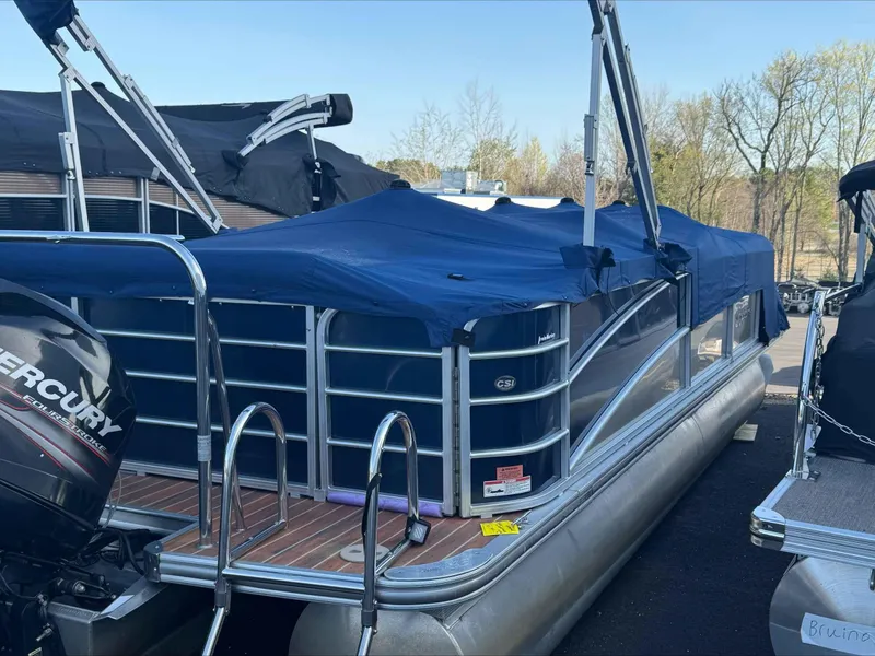 Slide: The Image of 2013 Berkshire 230CL STS pontoon boat with blue cover and Mercury outboard motor. - 3